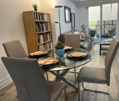 a living room with a dining table and chairs at Studio City Chic Large Contemporary Condo in Los Angeles