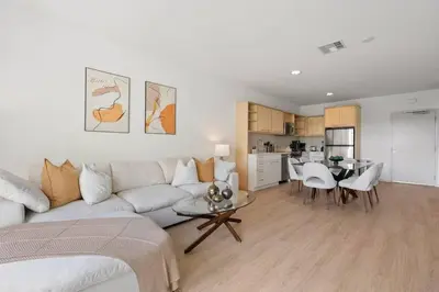 a living room with a white couch and a table at Emerald Ridge - Luxe Hollywood Walk of Fame in Los Angeles