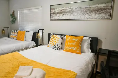 a bedroom with two beds with pillows on them at Relaxing Cozy Back House with Backyard in Upland