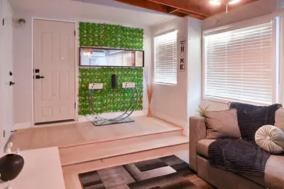 a living room with a couch and a green wall at Relaxing Cozy Back House with Backyard in Upland
