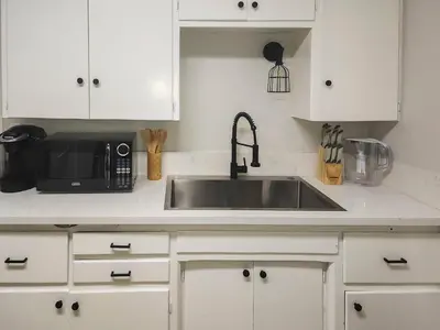 a kitchen counter with a sink and a microwave at Relaxing Cozy Back House with Backyard in Upland