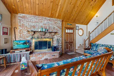 a living room with a couch and a fireplace at Villa Elvira in Lake Arrowhead