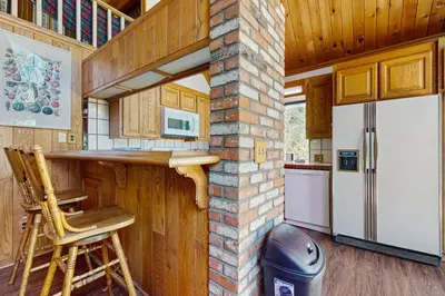 a kitchen with a counter and a refrigerator at Villa Elvira in Lake Arrowhead
