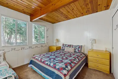 a bedroom with a bed and a wooden ceiling at Villa Elvira in Lake Arrowhead