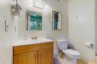 a bathroom with a white toilet and a sink at Villa Elvira in Lake Arrowhead