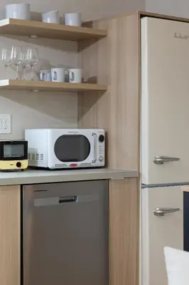 a microwave sitting on top of a kitchen counter at Luxe 2BR with Designer Touches, Walk to Everything in Los Angeles