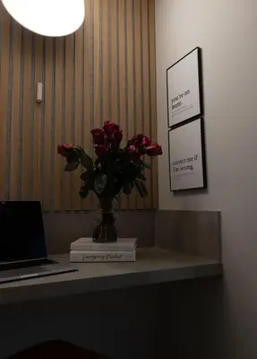 a vase of flowers on a desk with a laptop at Luxe 2BR with Designer Touches, Walk to Everything in Los Angeles