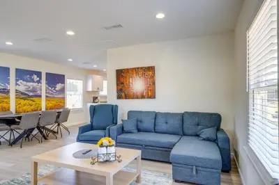 a living room with a blue couch and a table at Walk to Dtwn Tehachapi Updated Getaway with Yard! in Tehachapi