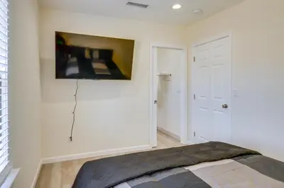 a bedroom with a bed and a painting on the wall at Walk to Dtwn Tehachapi Updated Getaway with Yard! in Tehachapi