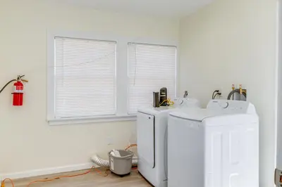 a white laundry room with two washers and a window at Walk to Dtwn Tehachapi Updated Getaway with Yard! in Tehachapi
