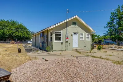 a small green house with a lot of gravel around it at Walk to Dtwn Tehachapi Updated Getaway with Yard! in Tehachapi