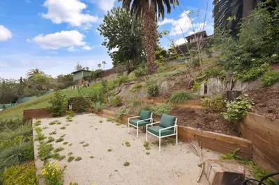 two chairs sitting in the sand in a garden at New Listing Hillside Villa by Colby & Conrad in Los Angeles