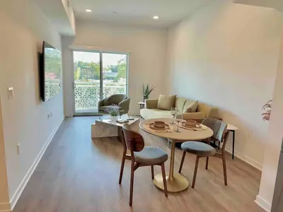 a living room with a table and chairs and a couch at Designer 1 Bedroom Condo in Silver Lake in Los Angeles