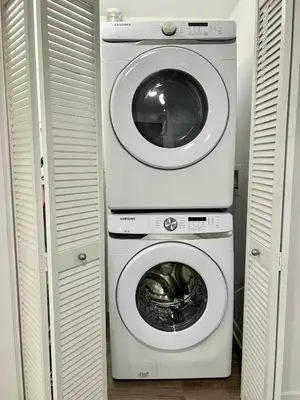 a washing machine and a dryer in a closet at Designer 1 Bedroom Condo in Silver Lake in Los Angeles