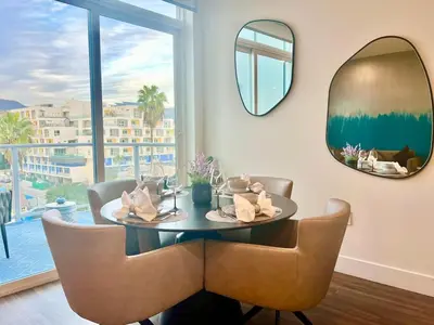 a dining room with a round table and a mirror at Penthouse with Hollywood Sign View 2 Bedrooms with 3 Beds in Los Angeles