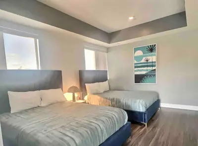 a bedroom with two beds and a window at Penthouse with Hollywood Sign View 2 Bedrooms with 3 Beds in Los Angeles