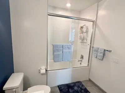 a bathroom with a shower with blue towels at Penthouse with Hollywood Sign View 2 Bedrooms with 3 Beds in Los Angeles