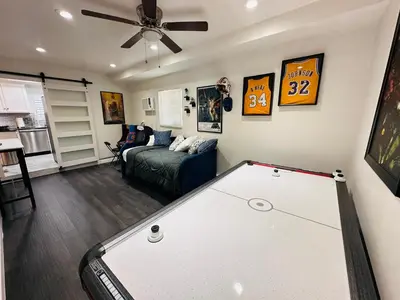 a living room with a couch and a ceiling fan at Echo House in Los Angeles