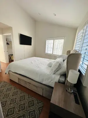 a bedroom with a bed and a table and a television at Echo House in Los Angeles
