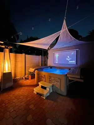 a large tv in a tent with a table at Echo House in Los Angeles