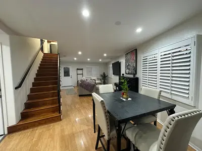 a dining room with a table and chairs and a staircase at Echo House in Los Angeles