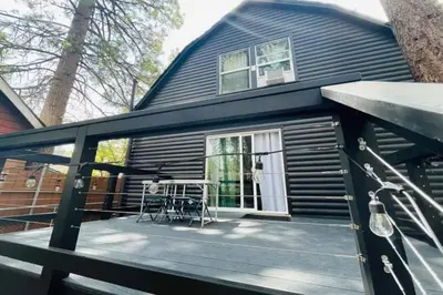 a house with a deck with a table at The Wilderness Haven in Big Bear Lake