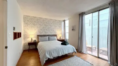 a bedroom with a bed and a large window at Charming 1BR in Prime Santa Monica Walk to Beach in Los Angeles