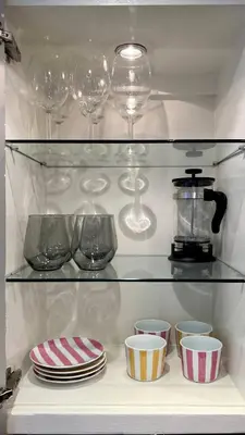 a shelf with plates and wine glasses and bowls at Charming 1BR in Prime Santa Monica Walk to Beach in Los Angeles