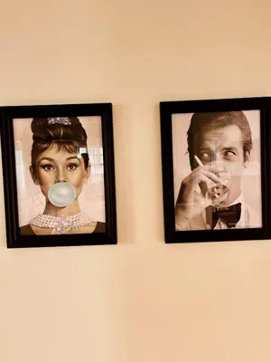 two pictures of a woman with a gas mask on a wall at Cozy Hollywood Cottage - Free Parking in Los Angeles