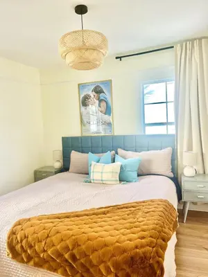 a bedroom with a large bed with a brown blanket at Cozy Hollywood Cottage - Free Parking in Los Angeles