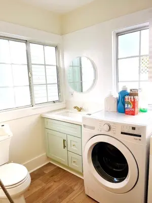 a white laundry room with a washer and a sink at Cozy Hollywood Cottage - Free Parking in Los Angeles