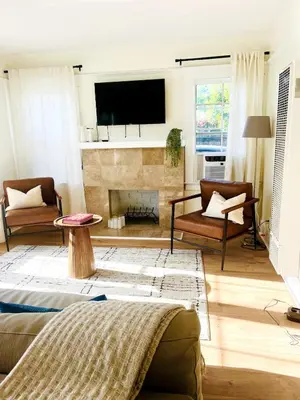 a living room with a couch and a fireplace at Cozy Hollywood Cottage - Free Parking in Los Angeles