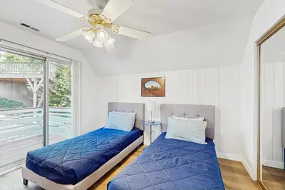 a bedroom with two beds and a ceiling fan at Bright Moon in Lake Arrowhead