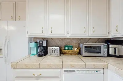 a kitchen with white cabinets and a microwave at Bright Moon in Lake Arrowhead