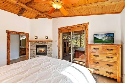a bedroom with a bed and a fireplace at California Dreaming: Lakeside Cabin Getaway in the Best Location in San Bernardino