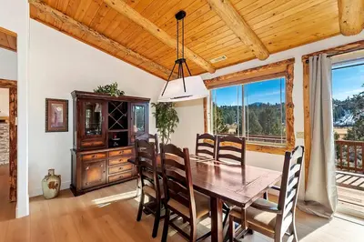 a dining room with a wooden table and chairs at California Dreaming: Lakeside Cabin Getaway in the Best Location in San Bernardino