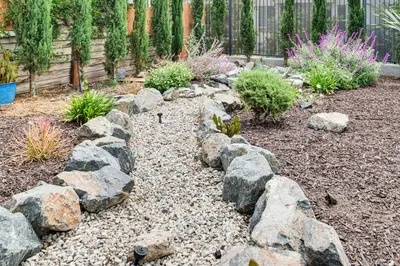 a garden with rocks and plants and a fence at 1 Mi to Dtwn LA Artists Retreat with Zen Garden in Los Angeles