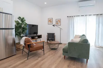a living room with a couch and a tv at New 2BR Family Home Nr Universal in Gemco