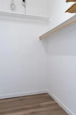 a room with a white wall and a wooden floor at New 2BR Family Home Nr Universal in Gemco