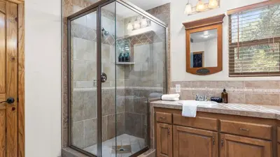 a bathroom with a shower and a sink at The Fairway Hideaway by AvantStay Game Room Outdoor Dining Near Lake Arrowhead in Lake Arrowhead