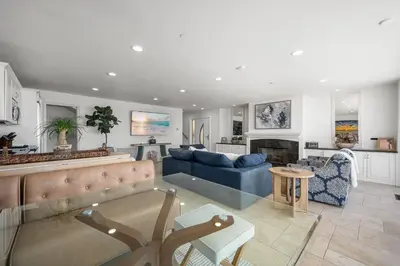 a living room with a blue couch and a fireplace at Ocean Views in Long Beach in Long Beach