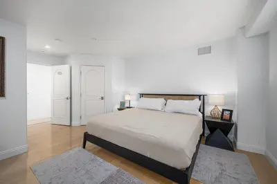 a bedroom with a bed and a white wall at Ocean Views in Long Beach in Long Beach