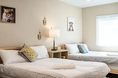 a living room with two beds and a couch at Heartwarming Family Stay 10 Min Walk to Pomona Valley Hospital in Pomona