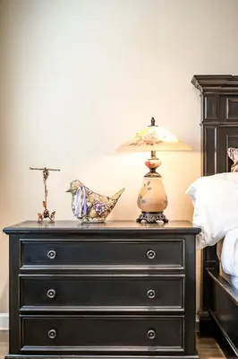 a bedroom with a black dresser with a lamp on it at Heartwarming Family Stay 10 Min Walk to Pomona Valley Hospital in Pomona
