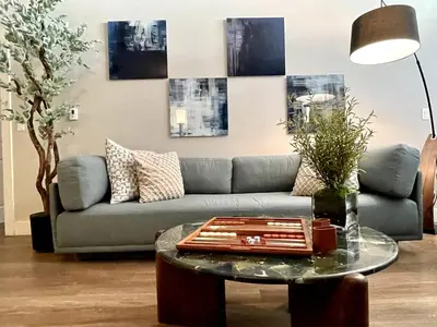 a living room with a couch and a table at Designer 2 Bedroom with 3 Beds- Pool View, Gym, Parking in Los Angeles