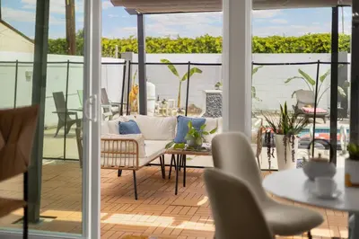 a living room with a white couch and a table at Stylish 5 Bedroom Villa with Pool near Disney - Luxury Family Retreat in Anaheim