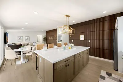 a kitchen and dining room with a large white counter top at Stylish 5 Bedroom Villa with Pool near Disney - Luxury Family Retreat in Anaheim