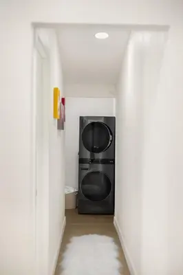 a hallway with a black microwave in a room at Stylish 5 Bedroom Villa with Pool near Disney - Luxury Family Retreat in Anaheim