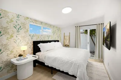 a bedroom with a bed and a table and a window at Stylish 5 Bedroom Villa with Pool near Disney - Luxury Family Retreat in Anaheim