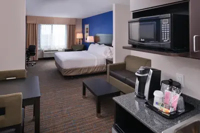 a hotel room with a bed and a television at Holiday Inn Express & Suites Bakersfield Airport by IHG in Bakersfield